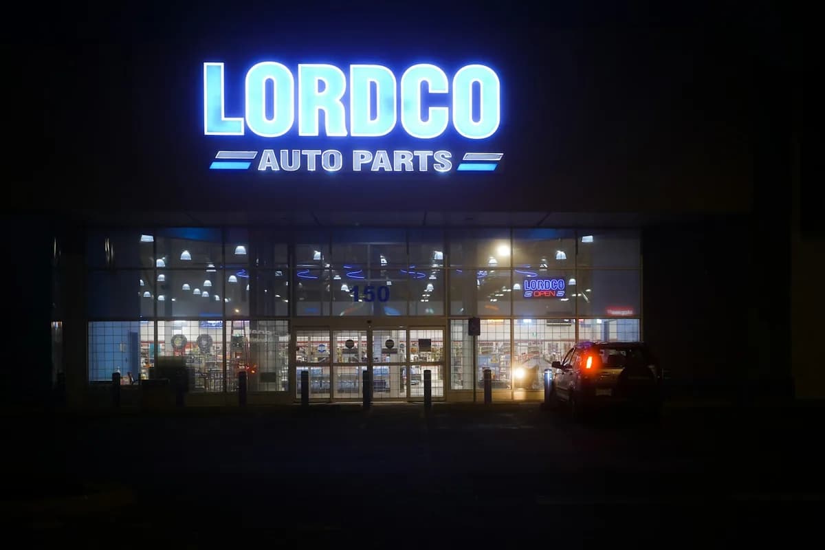 Lordco Auto Parts retail storefront with lit shelves visible through glass