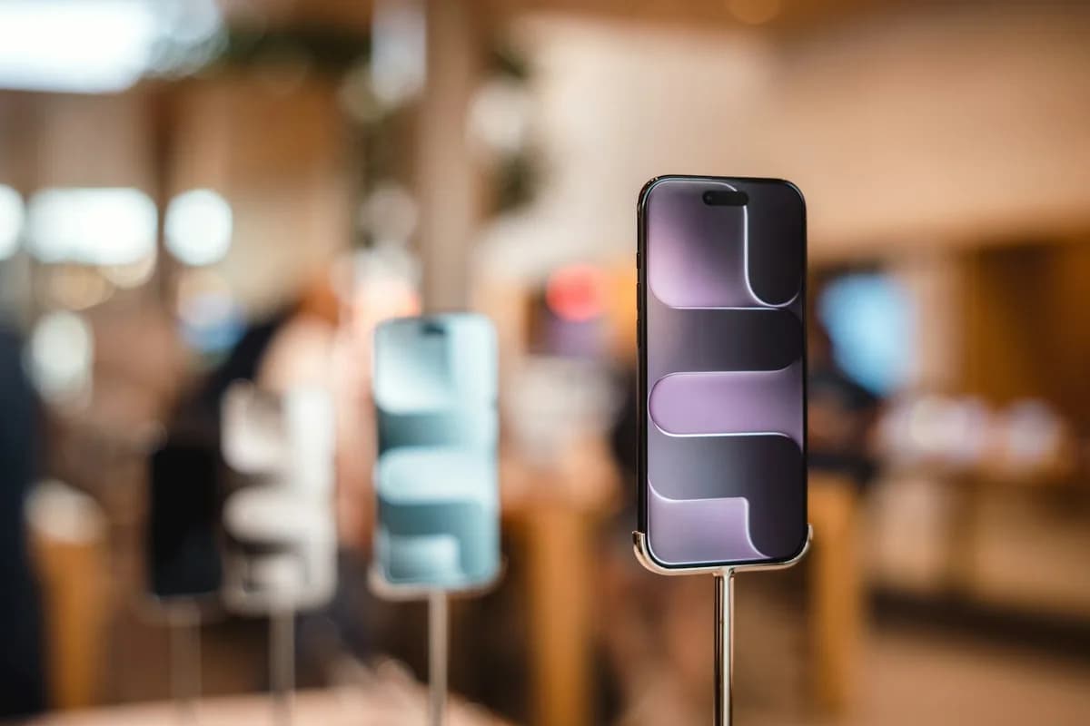 Smartphones displayed on stands inside an electronics retail store