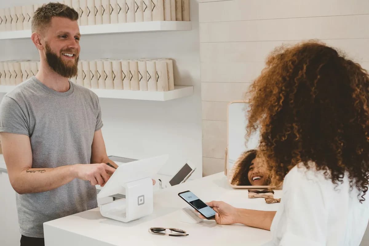Cashier and customer at a small retail shop POS counter