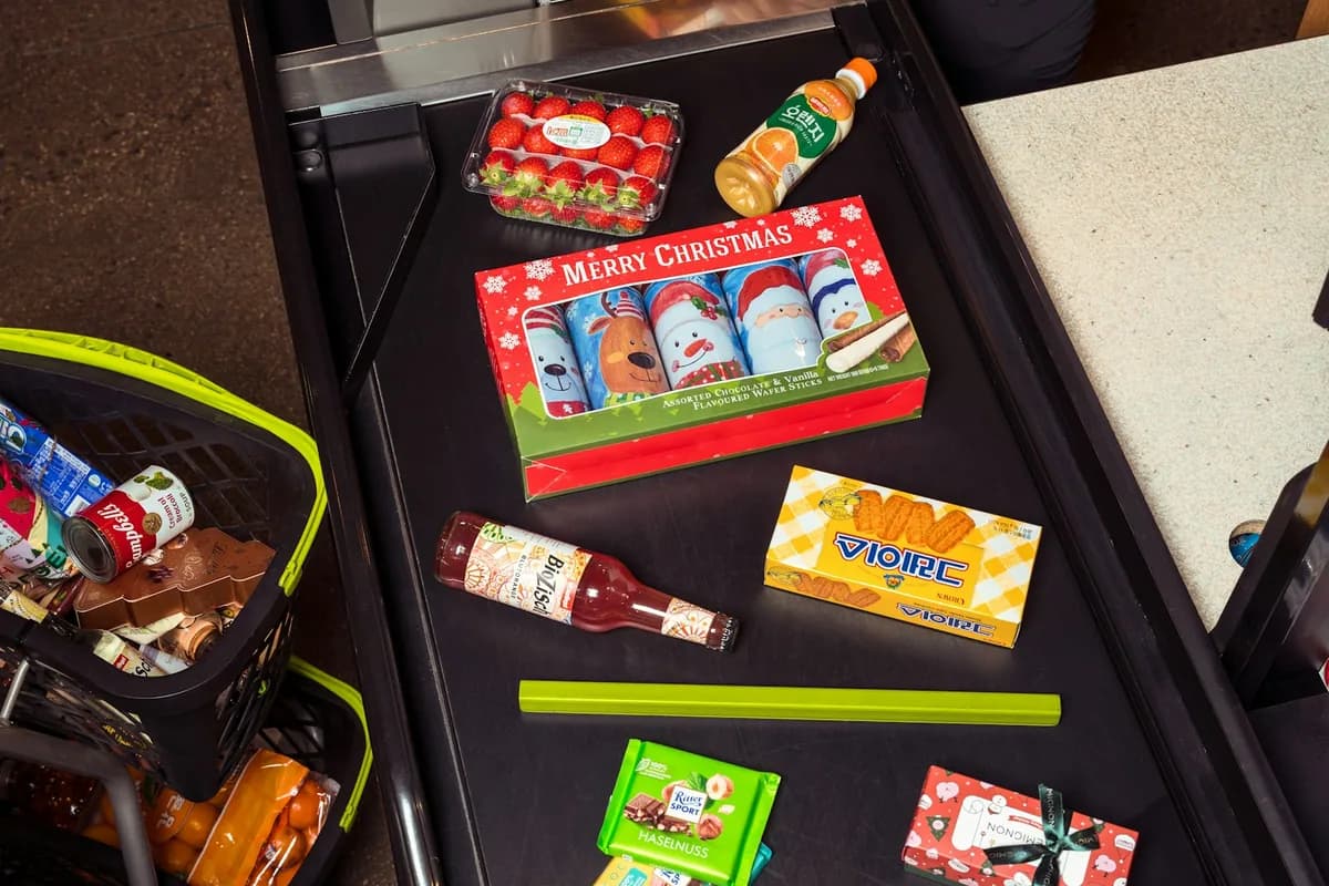 Grocery items being scanned at a supermarket checkout counter