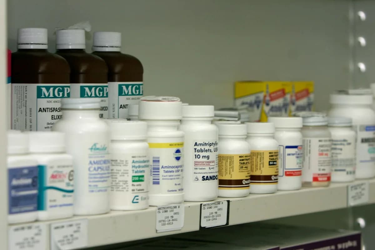 Prescription medicine bottles arranged on a retail pharmacy shelf